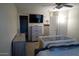 This bedroom offers neutral decor and a ceiling fan, and plush carpeting at 11601 W Bloomfield Rd, El Mirage, AZ 85335