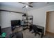 This bedroom is equipped with multiple monitors and a ceiling fan at 11601 W Bloomfield Rd, El Mirage, AZ 85335