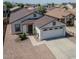Charming single-story home featuring a two-car garage, neutral paint, and low maintenance desert landscaping at 11601 W Bloomfield Rd, El Mirage, AZ 85335
