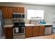 Kitchen features stainless steel appliances, oak cabinets, and light countertops at 11601 W Bloomfield Rd, El Mirage, AZ 85335