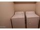 Bright laundry room featuring a white washing machine and dryer for convenient home functionality at 11601 W Bloomfield Rd, El Mirage, AZ 85335