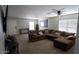 Spacious living room featuring neutral walls and carpet, a ceiling fan, and lots of natural light at 11601 W Bloomfield Rd, El Mirage, AZ 85335
