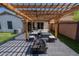 Backyard pergola offering a comfortable outdoor living space with patio furniture, a fire pit, and low-maintenance yard at 11601 W Bloomfield Rd, El Mirage, AZ 85335