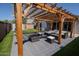 Stylish outdoor living space featuring pergola, patio with fire pit, outdoor furniture, artificial turf and shed at 11601 W Bloomfield Rd, El Mirage, AZ 85335