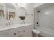 Tastefully updated bathroom features double sinks, marble countertop, and walk in shower at 12234 S Pewaukee St, Phoenix, AZ 85044