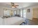 Bright bedroom features a mirrored closet, ceiling fan, and access to the pool area at 12234 S Pewaukee St, Phoenix, AZ 85044