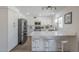 Modern kitchen with stainless steel appliances, white cabinets, quartz countertops and breakfast bar with seating at 12234 S Pewaukee St, Phoenix, AZ 85044