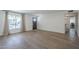 Open-concept living room with modern flooring, large window, and access to the rest of the house at 12234 S Pewaukee St, Phoenix, AZ 85044