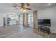 Open concept living space offering hardwood floors, large windows, and views into the outdoor pool area at 12234 S Pewaukee St, Phoenix, AZ 85044