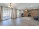 Spacious living room with brick fireplace, hardwood floors, and sliding glass doors for ample natural light at 12234 S Pewaukee St, Phoenix, AZ 85044