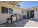 A covered patio features an outdoor kitchen with a stainless steel grill, and a propane tank for cooking at 12234 S Pewaukee St, Phoenix, AZ 85044