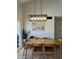 Inviting dining area with modern lighting and Gathering pictures, perfect for gatherings and creating memories at 1319 E Piute Ave, Phoenix, AZ 85024