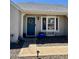 Inviting front entrance with a blue door, decorative wreath, and bay window adding charm and natural light at 1319 E Piute Ave, Phoenix, AZ 85024