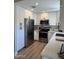 Well-appointed kitchen with stainless steel appliances, white cabinets, and stylish countertops, offering convenience and sophistication at 1319 E Piute Ave, Phoenix, AZ 85024