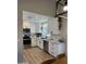 Modern kitchen features white cabinets, stainless steel appliances, and sleek countertops, creating a stylish cooking space at 1319 E Piute Ave, Phoenix, AZ 85024
