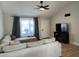 Cozy living room features a sectional sofa, ceiling fan, and large window, perfect for relaxation and entertainment at 1319 E Piute Ave, Phoenix, AZ 85024