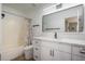 This bathroom has a shower-tub combo, sleek vanity, and white cabinets at 13864 W Ironwood St, Surprise, AZ 85374