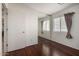 This bedroom has hardwood floors, a wide window, and a mirrored closet at 13864 W Ironwood St, Surprise, AZ 85374