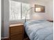 This bright bedroom has hardwood floors and a large window letting in natural light at 13864 W Ironwood St, Surprise, AZ 85374