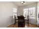 Breakfast nook with tiled floors, a round wood table, and window views to the front yard at 13864 W Ironwood St, Surprise, AZ 85374