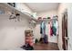 A large closet with shelving and hanging racks provides lots of room for clothes and storage at 13864 W Ironwood St, Surprise, AZ 85374