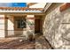 Beige single story home with a wood front door and desert landscaping with bright blue skies and scattered clouds at 13864 W Ironwood St, Surprise, AZ 85374