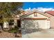 Charming single-story home featuring a two-car garage, desert landscaping and a welcoming front porch at 13864 W Ironwood St, Surprise, AZ 85374