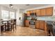 Well-lit kitchen with stainless steel appliances, wood cabinets and a cozy breakfast nook at 13864 W Ironwood St, Surprise, AZ 85374