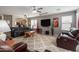 Spacious living room featuring a ceiling fan, plush carpet, and comfortable seating, great for relaxing at 13864 W Ironwood St, Surprise, AZ 85374