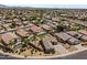 A beautiful aerial view showcasing homes with tile roofs, desert landscaping, and refreshing private pools at 14621 W Catalina Dr, Goodyear, AZ 85395