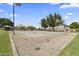 A community basketball court is ready for a game on a clear day with trees and blue skies at 14621 W Catalina Dr, Goodyear, AZ 85395