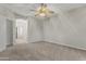 This bedroom offers neutral walls, neutral carpet and a ceiling fan at 14621 W Catalina Dr, Goodyear, AZ 85395