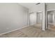 Bedroom with light gray walls, neutral carpeting and a mirrored closet at 14621 W Catalina Dr, Goodyear, AZ 85395