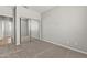 Bedroom featuring neutral walls, carpet, mirrored closet doors, and white trim at 14621 W Catalina Dr, Goodyear, AZ 85395