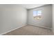 Bedroom features neutral walls, carpet, and a view of the street at 14621 W Catalina Dr, Goodyear, AZ 85395