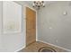 Neutral entryway with tile floors, a chandelier, and a wood door at 14621 W Catalina Dr, Goodyear, AZ 85395