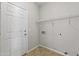 Functional laundry area with tile flooring, shelf and utility hookups at 14621 W Catalina Dr, Goodyear, AZ 85395
