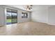 Neutral living room with tile floors and sliding glass door access to backyard at 14621 W Catalina Dr, Goodyear, AZ 85395