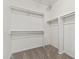Walk-in closet featuring carpet and white shelves at 14621 W Catalina Dr, Goodyear, AZ 85395