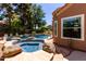 Inviting backyard pool and spa area with stone accents and tranquil landscaping for ultimate relaxation at 1521 W Kent Dr, Chandler, AZ 85224