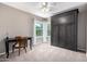 Bedroom featuring an accent wall and a built-in wardrobe with windows providing natural light at 1521 W Kent Dr, Chandler, AZ 85224