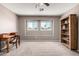 Bedroom featuring a ceiling fan, neutral walls, and windows providing natural light at 1521 W Kent Dr, Chandler, AZ 85224