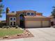 Two-story home features a red tile roof, stucco exterior, three-car garage, and arched entry at 1521 W Kent Dr, Chandler, AZ 85224