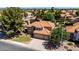 Aerial view of a two-story home featuring a red tile roof, well-manicured lawn, and mature trees at 1521 W Kent Dr, Chandler, AZ 85224