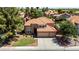 Beautiful two-story home with a three-car garage, well-manicured lawn, and tile roof at 1521 W Kent Dr, Chandler, AZ 85224