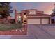 Stunning two-story home featuring a three-car garage and a well-manicured front yard at 1521 W Kent Dr, Chandler, AZ 85224