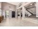 Grand foyer boasting soaring ceilings, tiled floors, and a staircase with iron railings at 1521 W Kent Dr, Chandler, AZ 85224