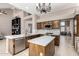 A kitchen showcases knotty wood cabinets, stainless appliances, white countertops, and an island at 1521 W Kent Dr, Chandler, AZ 85224