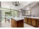 Kitchen showcasing wood cabinets, stainless appliances, an island, and adjacent dining area at 1521 W Kent Dr, Chandler, AZ 85224