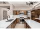 Modern kitchen featuring custom wood cabinets, quartz countertops, and stainless steel appliances at 1521 W Kent Dr, Chandler, AZ 85224